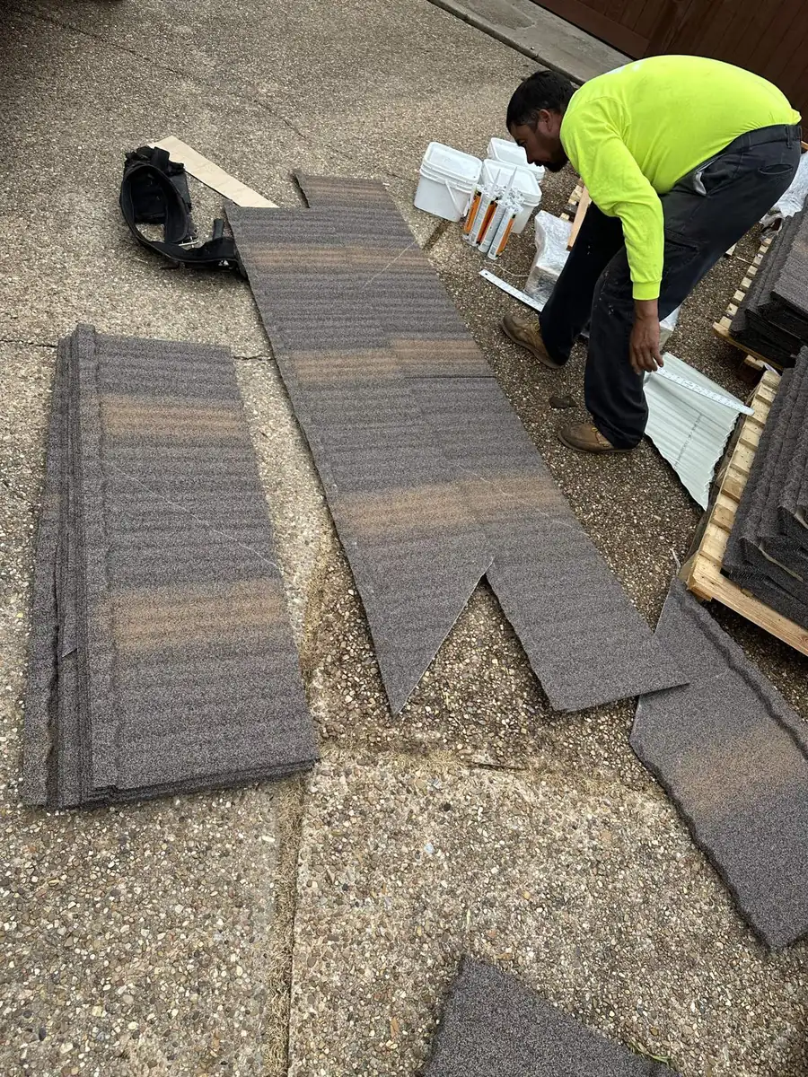 Stone-coated steel shake panels being cut on site