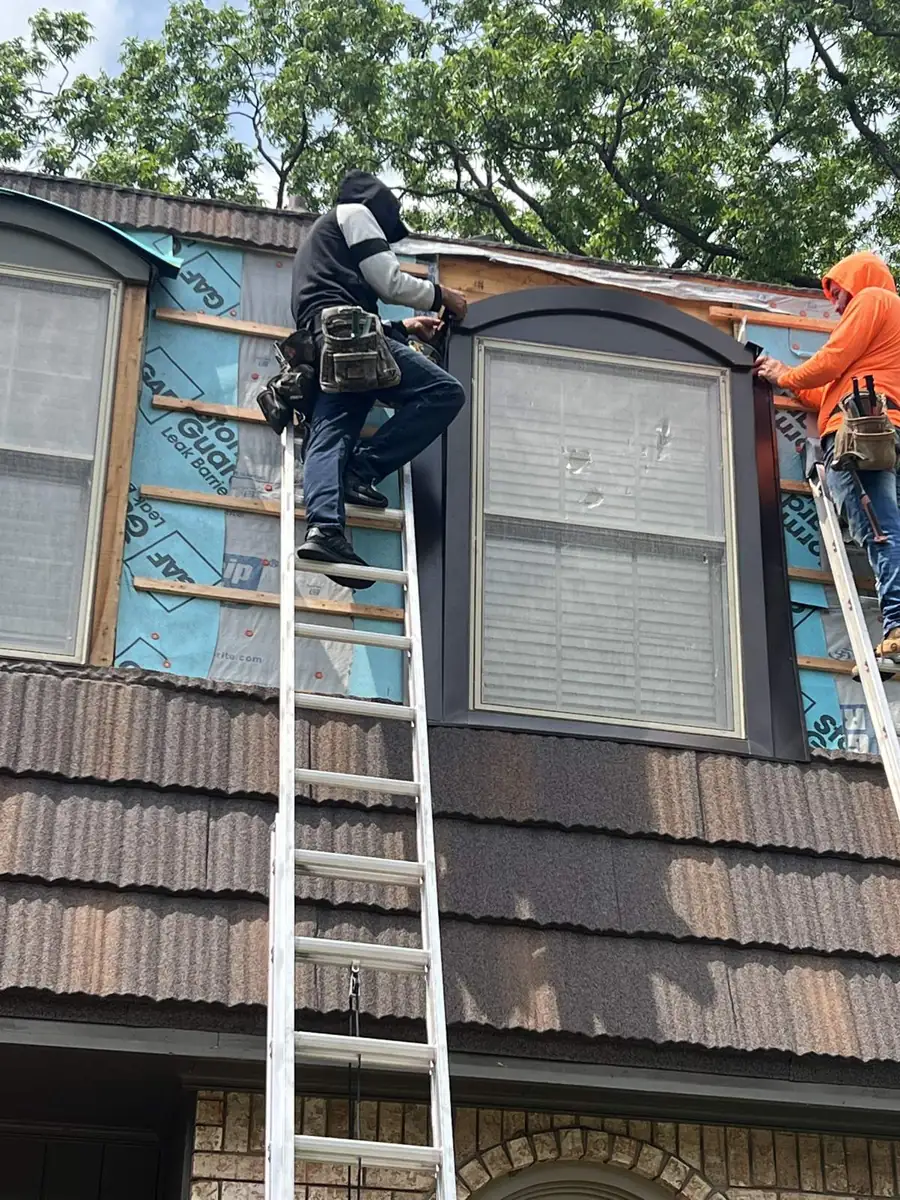 Crew working from ladders during the install